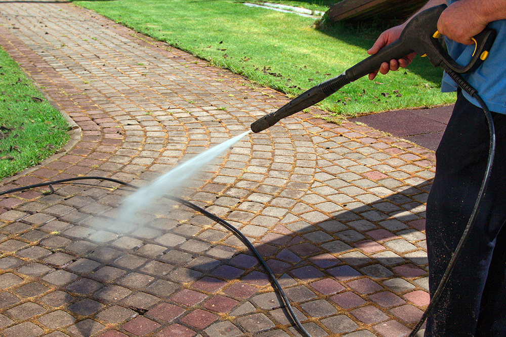 Pressure Washing 101: Everything You Need to Know About This Cleaning Method 8 cleaning street with high pressure power washer